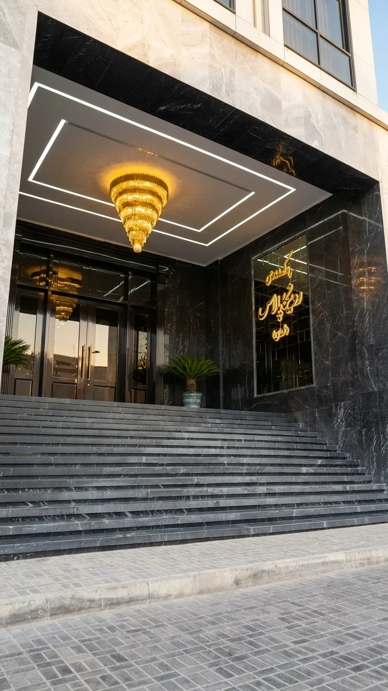Grand marble entrance of Ronika Palace with gold chandelier above the steps